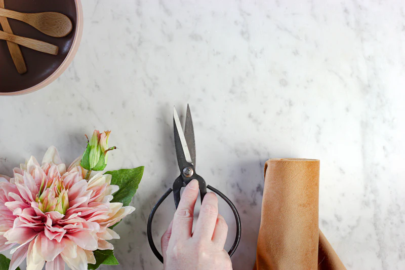 Dahlia, flower shears and kraft paper on a marble table